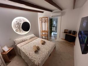 a bedroom with a bed with two pillows on it at Fuera de tiempo in Albalat de la Ribera