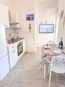 a kitchen and dining room with a table and chairs at Ginestra in Campese +2 photos
