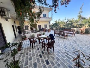 a patio with benches and tables and a building at Keshav Palace in Pushkar