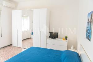 a bedroom with a blue bed and a mirror at Ginestra in Campese