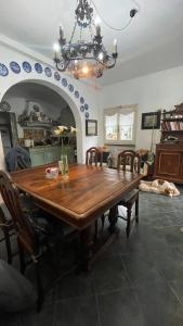 a dining room with a wooden table and chairs at Eucalipto in Sestri Levante