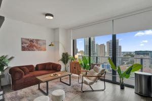 a living room with a couch and a large window at Cadenza Miami - Luxury Residences in Miami +49 photos