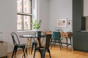 a dining room with a table and chairs and a desk at The Alexander - Old Montreal in Montreal +49 photos