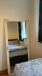 a mirror in the corner of a bedroom with a bed at 83 Clonmullion Athy county Kildare in Athy