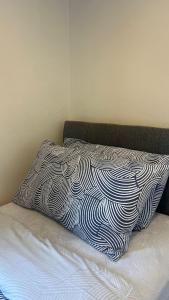 a bed with a black and white pillow on it at 83 Clonmullion Athy county Kildare in Athy +4 photos