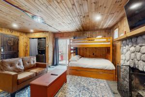 a bedroom with a bed and a couch in a room at Fornuto Cabin in Wardsboro