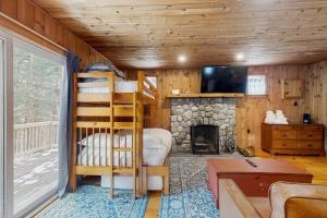 a room with a bunk bed and a fireplace at Fornuto Cabin in Wardsboro