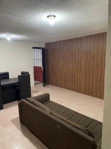 a living room with a couch and a desk at Casa Fuentes in Zacatlán