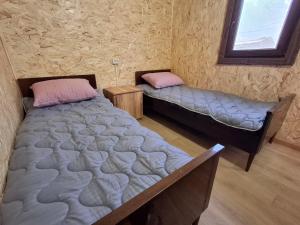 a bedroom with two beds and a window at Shiraz in Agarak +13 photos