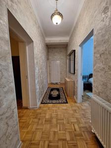 an empty room with a hallway with a room with a floor at Central Apartment Tskaltubo in Tsqaltubo