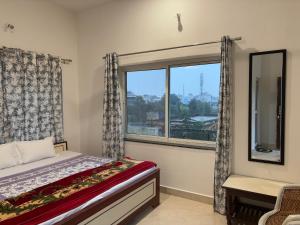 a bedroom with a bed and a window with a view at Keshav Palace in Pushkar