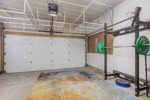 a garage with white garage doors and a gym at Spacious Denver Home with Private Rooftop Spa in Denver