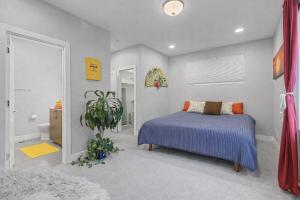 a bedroom with a bed and a bathroom at Spacious Denver Home with Private Rooftop Spa in Denver