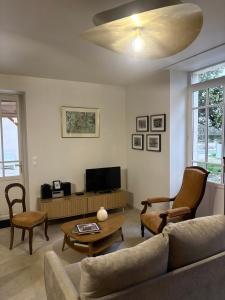 a living room with a couch and a table at La marmotte in Le Vanneau