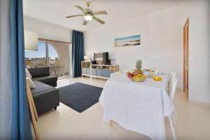 a living room with a table with fruit on it at Casa Azul 3 - Senhora da Rocha, Algarve in Porches