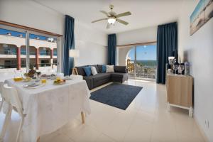 a living room with a table and a couch at Casa Azul 3 - Senhora da Rocha, Algarve in Porches