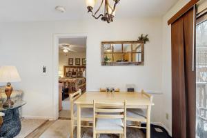 a dining room with a wooden table and chairs at Misty Woods #4 in Sugar Mountain