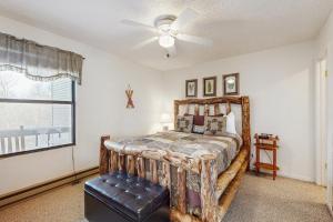 a bedroom with a bed and a ceiling fan at Misty Woods #4 in Sugar Mountain