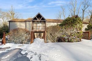 a house is covered in snow with a yard at Misty Woods #4 in Sugar Mountain