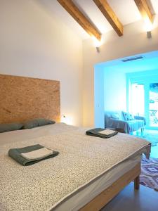 a bedroom with a bed with two towels on it at La Llar de la Font in Barraca de Aguas Vivas +54 photos