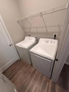 a laundry room with a sink and a washing machine at Graphite Loft in Des Moines +20 photos
