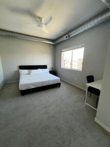 a bedroom with a bed and a ceiling fan at Graphite Loft in Des Moines
