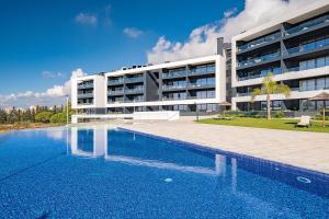 a swimming pool in front of a building at Luxury T2 Apartment With Ocean View in Portimão