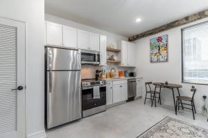a kitchen with a stainless steel refrigerator and a table at Park Hotel Studio Suite 407 in Chattanooga