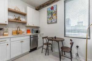 a kitchen with white cabinets and a table and chairs at Park Hotel Studio Suite 407 in Chattanooga +20 photos