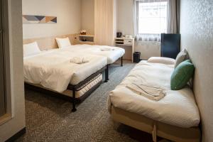 a hotel room with two beds and a window at Hotel Il Fiore Kasai Annex in Tokyo +23 photos