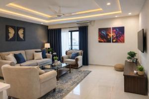 a living room with a couch and chairs at The Nest Apartment in Rawalpindi