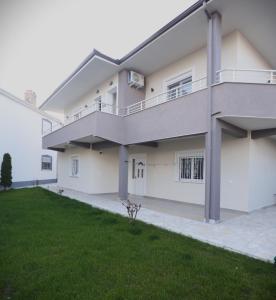 a large white house with a green yard at The Swan Nest 1 in Pogradec