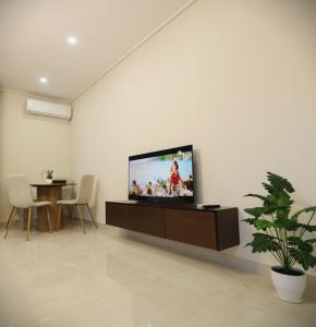 a living room with a flat screen tv on a wall at The Swan Nest 1 in Pogradec