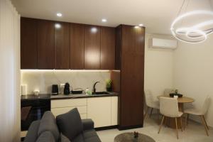 a kitchen and a living room with a couch and a table at The Swan Nest 1 in Pogradec +9 photos