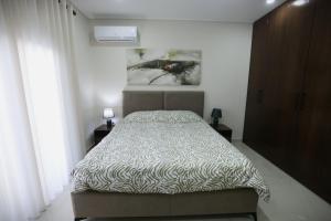 a bedroom with a bed and a painting on the wall at The Swan Nest 1 in Pogradec