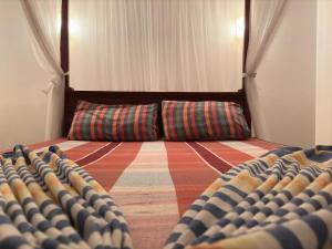 an empty room with a bed and a couch at Fairview Villa in Hikkaduwa