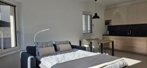a bedroom with a bed and a table and a kitchen at River2Mountain Cozy Apartment in Gozd Martuljek