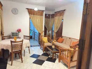 a living room with a couch and a table at Fairview Villa in Hikkaduwa