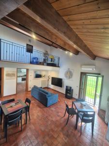 a living room with a blue couch and tables and chairs at B&B Bella di Notte in Lugo