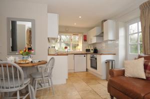 a kitchen and living room with a table and chairs at Stocks Barn in Liskeard