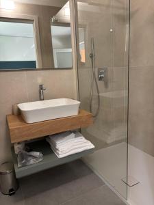 a bathroom with a sink and a glass shower at Giorgia's House in Silvi Marina
