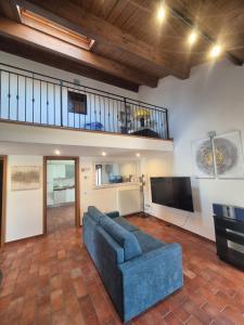 a living room with a blue couch and a flat screen tv at B&B Bella di Notte in Lugo
