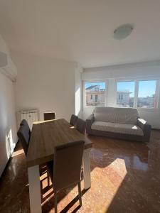 a living room with a table and a couch at Casa Francesco in Rapallo