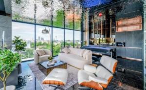 a living room with white furniture and a large window at Bangkok Esque Sukhumvit101 Condo NEW Building in Amphoe Phra Khanong