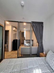 a bedroom with a bed and a room with a bathroom at Bangkok Esque Sukhumvit101 Condo NEW Building in Amphoe Phra Khanong +96 photos