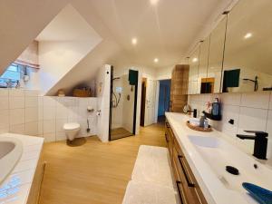 a large bathroom with a sink and a shower at Ferienzimmer Claudia in Surwold +17 photos