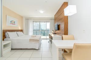 a hotel room with a bed and a desk at Vision Hotel em Brasília 84573 in Brasília