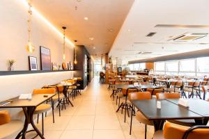 a dining room with tables and chairs at Vision Hotel em Brasília 84573 in Brasília