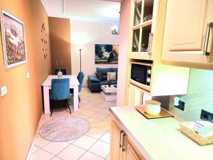 a kitchen with a table and a living room at Apartament me qira ditore "AGA"Fier in Fier