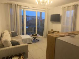 a living room with a couch and a tv in it at BLEU AZUR in Fréjus